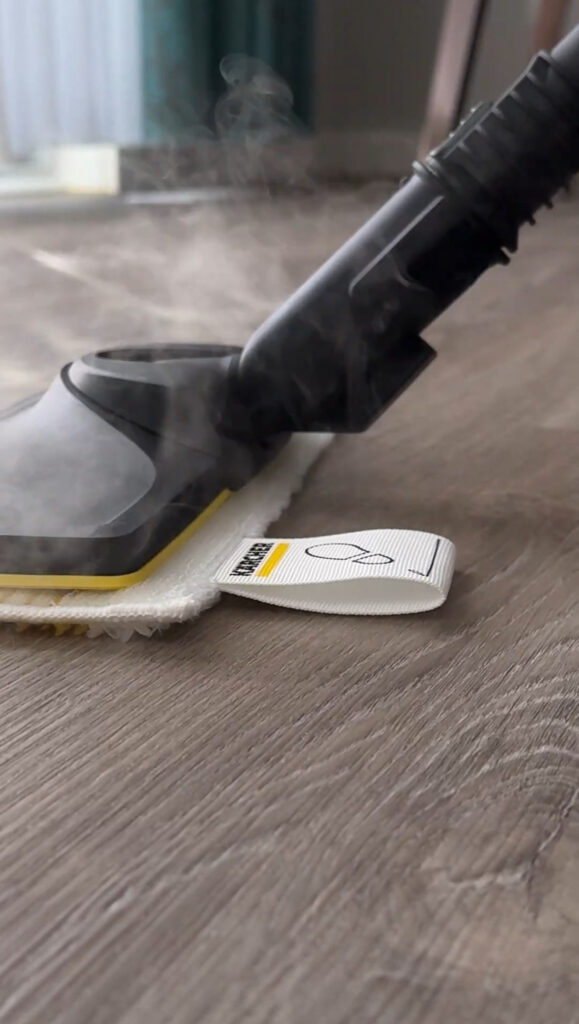 Professional-grade steam cleaner lifting dirt from tile floor during deep cleaning service